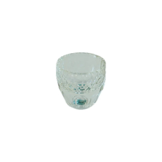 Clear glass cup with decorative elements on a white background