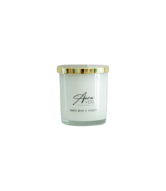 Aura&Co Candle in a clear container with a gold lid on a white background