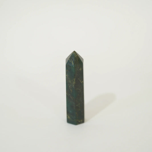 A polished emerald point tower with natural gold veining, standing upright on a clean white background.