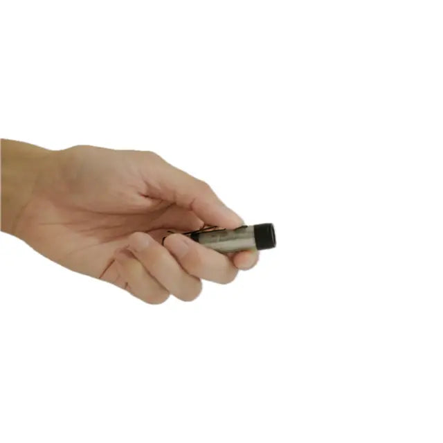 A person’s hand holding a WELLHIKE– Rechargeable Torch against a white background.