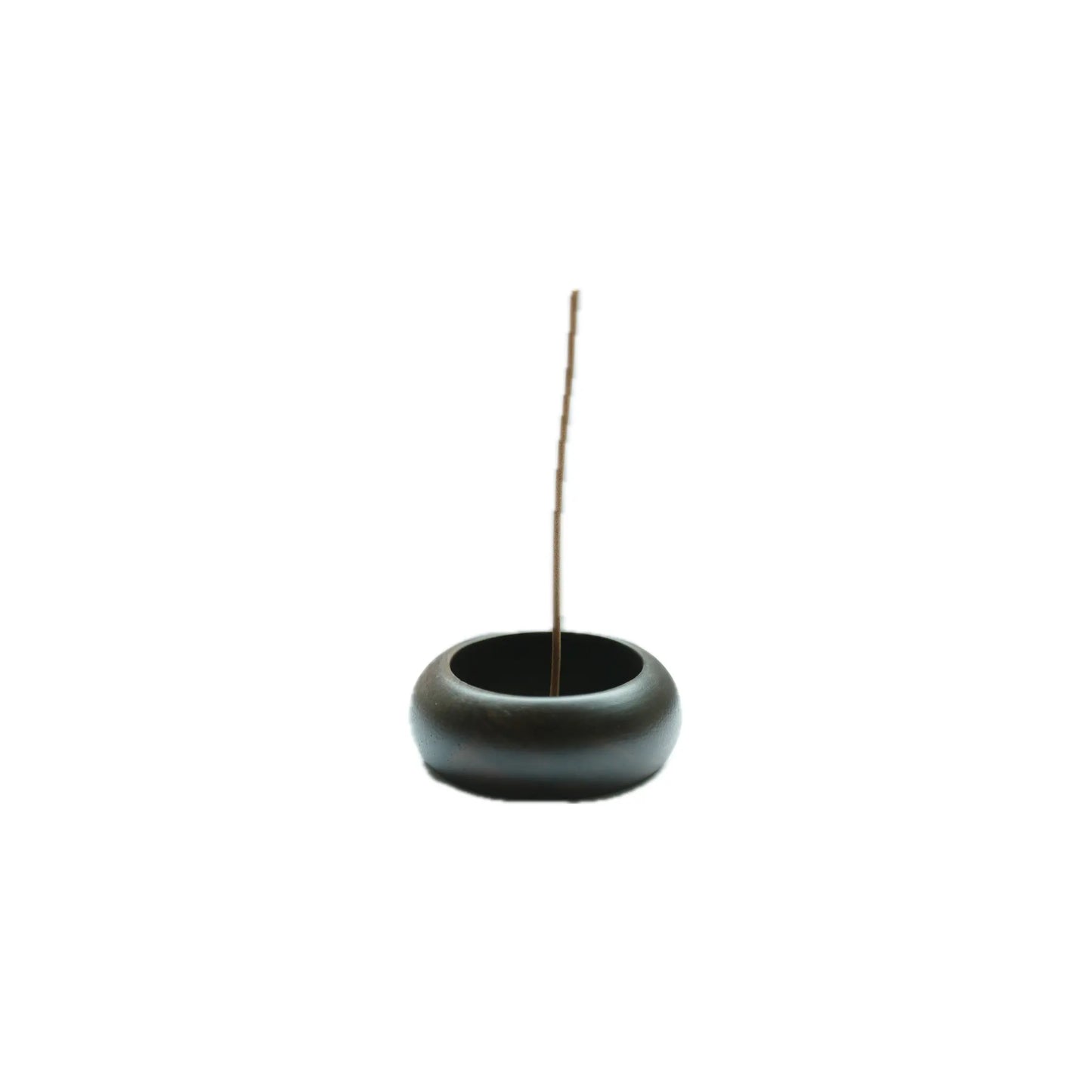 Black wood incense burner with a single incense stick on a white background