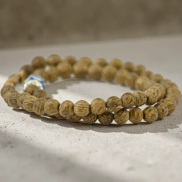 Wooden beaded bracelets on a light surface