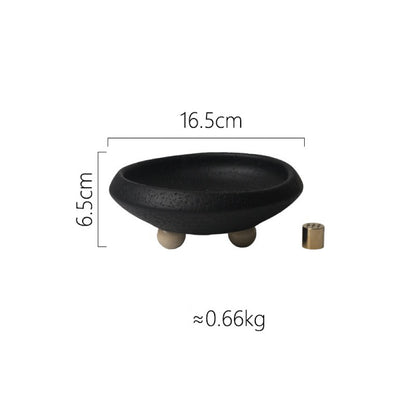 A black decorative bowl with a textured finish, measuring 16.5cm in diameter and 6.5cm in height, resting on three beige feet.