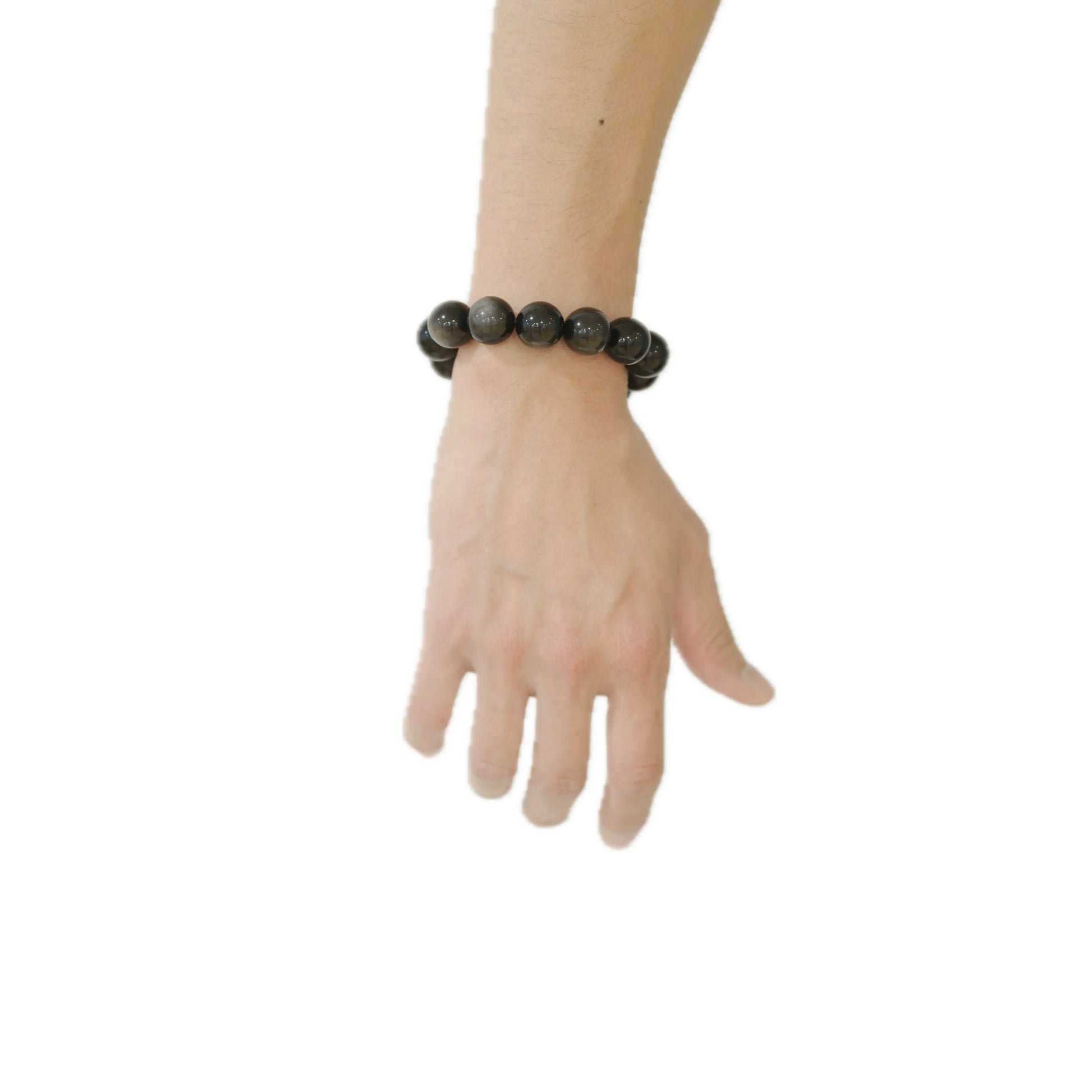 A close-up view of the 18mm Silver Sheen Obsidian crystal bracelet worn on a wrist, demonstrating the bold scale and the stone’s powerful grounding energy against a minimalist background at Singoau.