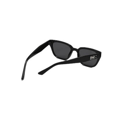 Black cat-eye sunglasses with dark lenses and stylish ridged detailing on the frame, angled to showcase their sleek design.