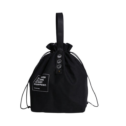 A stylish black canvas drawstring lunch bag featuring motivational text and smiley face icons, perfect for casual and everyday use.