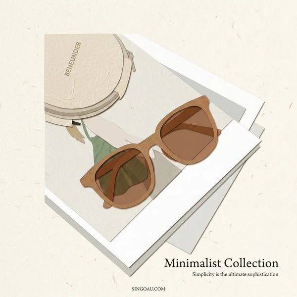 A pair of brown wooden-framed sunglasses with dark brown lenses, resting on a white magazine page next to a beige round case. The image is presented as a styled flat-lay on a textured cream background with the text 'Minimalist Collection' and 'SINGOAU.