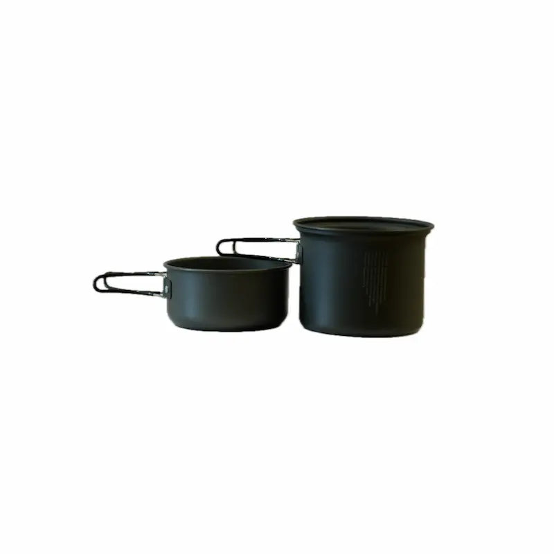 Two dark gray cooking pots with metal handles, one larger and taller than the other, positioned side by side on a white background.