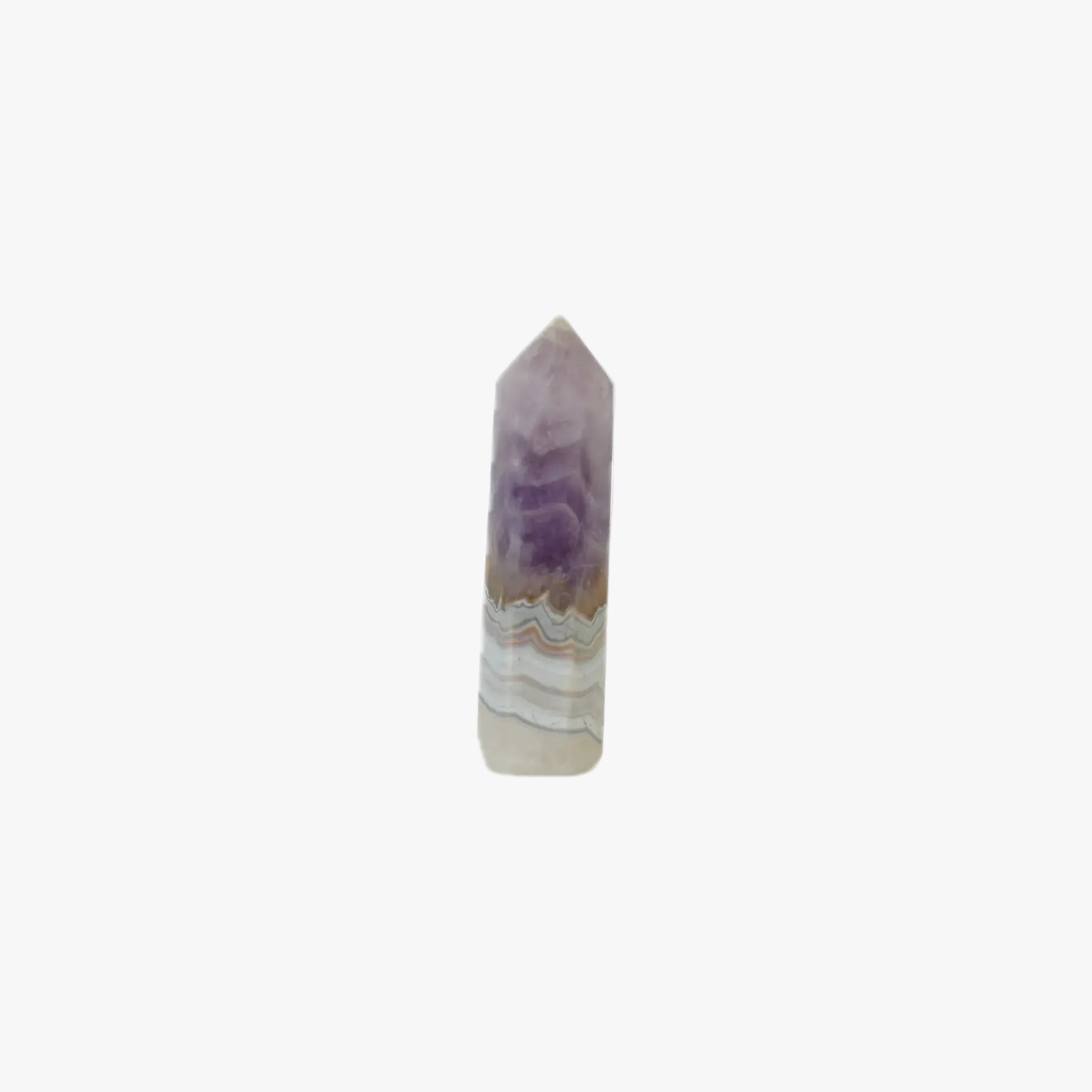 A natural amethyst crystal point with concentric bands of purple, beige, and white agate, isolated on a solid white background.