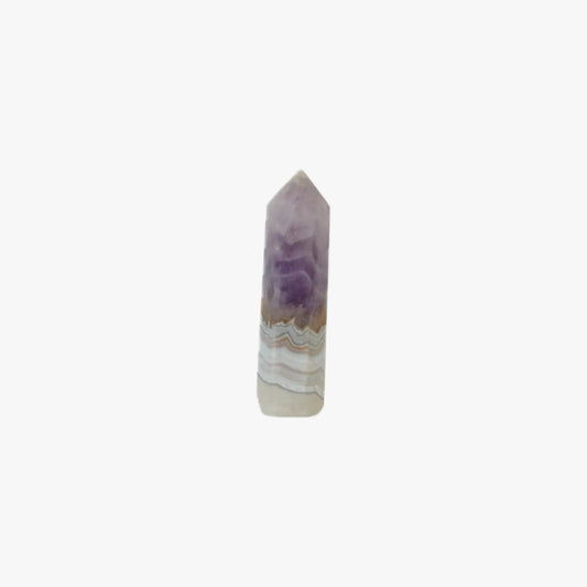 A natural amethyst crystal point with concentric bands of purple, beige, and white agate, isolated on a solid white background.