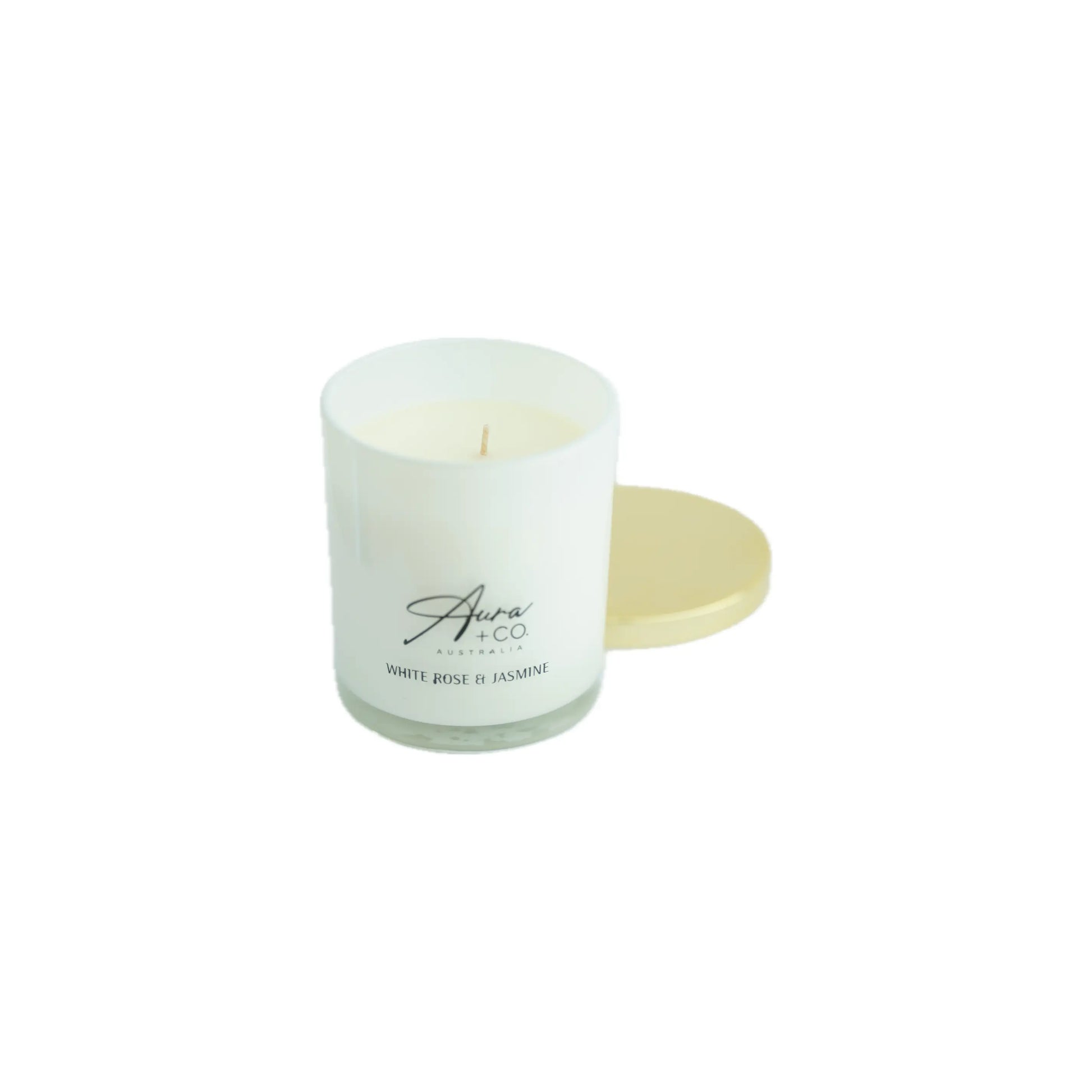 White  rose and Jasmine candle in a glass container with a gold color coaster on a white background