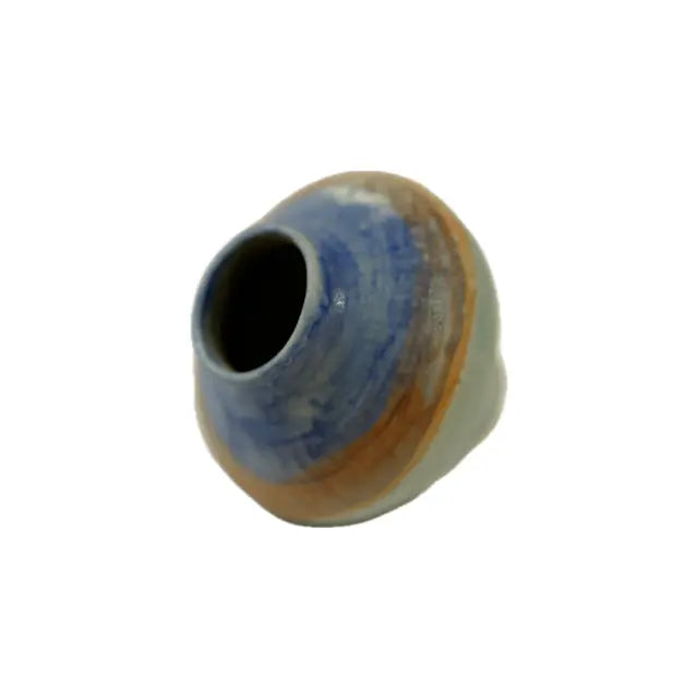 Ceramic vase with blue and beige design on a white background