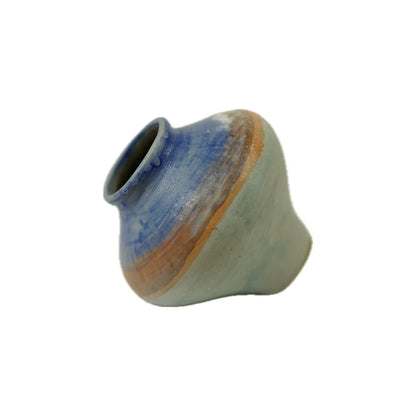 A uniquely shaped ceramic vase with a smooth surface, featuring blue and earthy tones that blend harmoniously together.