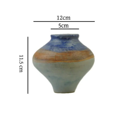 A small ceramic vase, 11.5 cm tall, 12 cm wide, with a textured blue and orange design against a white background.