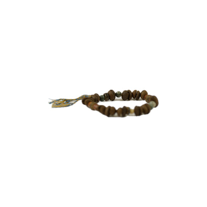 A handmade bracelet featuring Coffee bean beads in various earthy tones, with a decorative tag and colorful string.