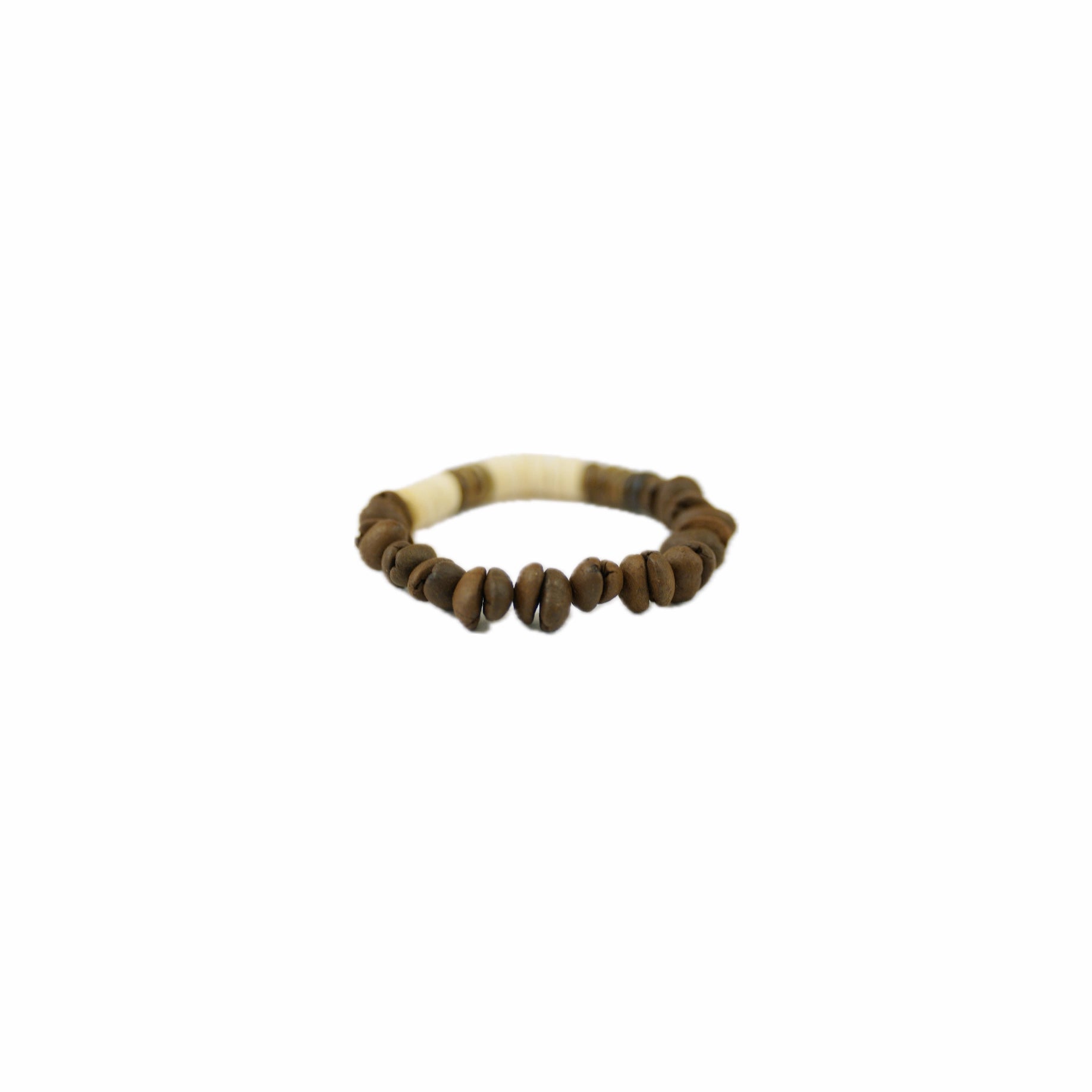 A handmade bracelet featuring coffee bean beads and a decorative ivory-like section, set against a plain background.