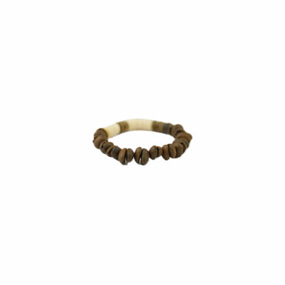 A handmade bracelet featuring coffee bean beads and a decorative ivory-like section, set against a plain background.