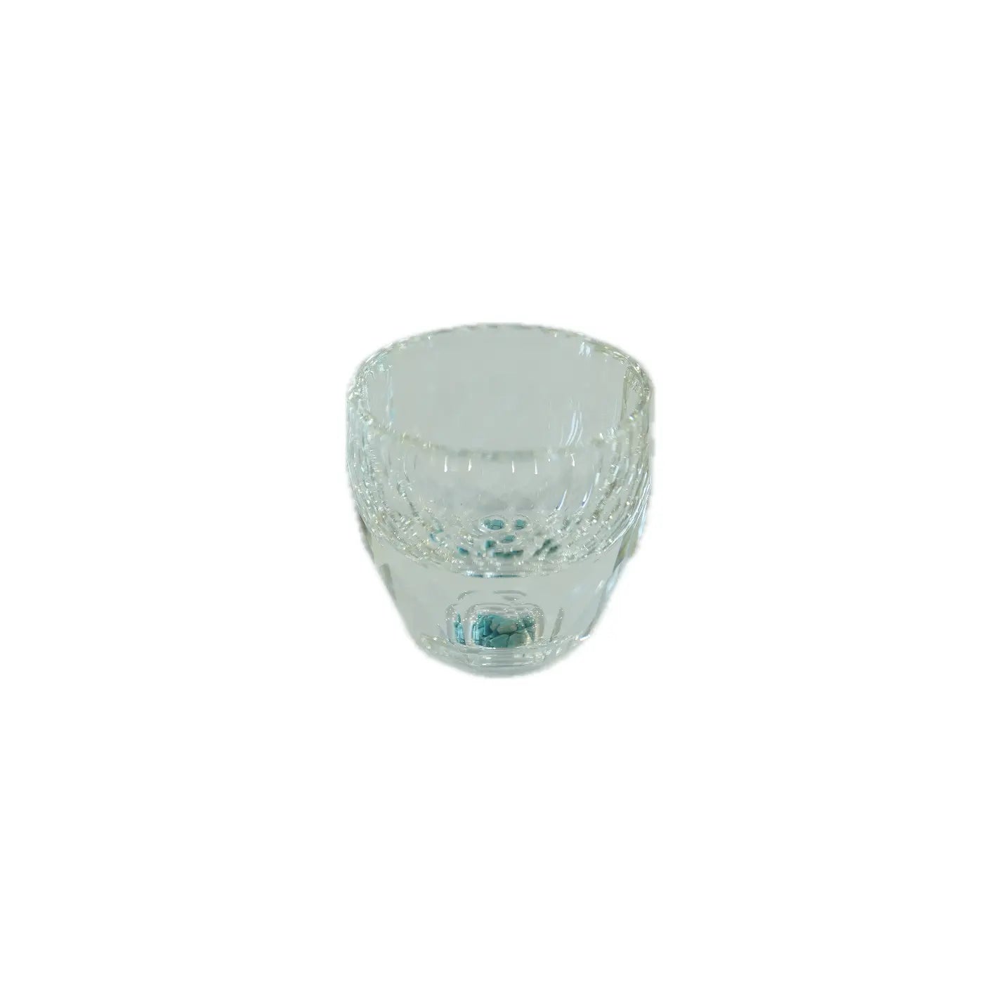 Clear glass cup with decorative elements on a white background