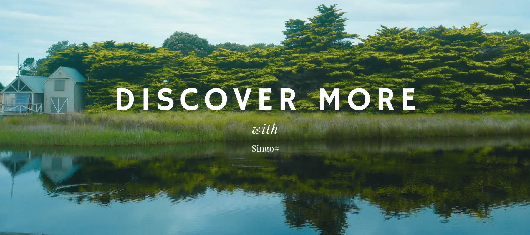 A line of green tree walls with a blue-roofed house in the end; the reflection on the lake surface makes the audience feel peace and quiet, and the white font of Discover More With Singo# is on the slide.