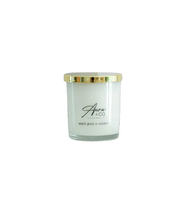 Aura&Co Candle in a clear container with a gold lid on a white background
