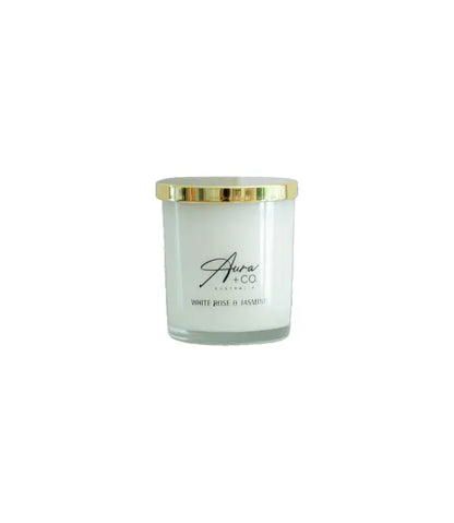 Aura&Co Candle in a clear container with a gold lid on a white background