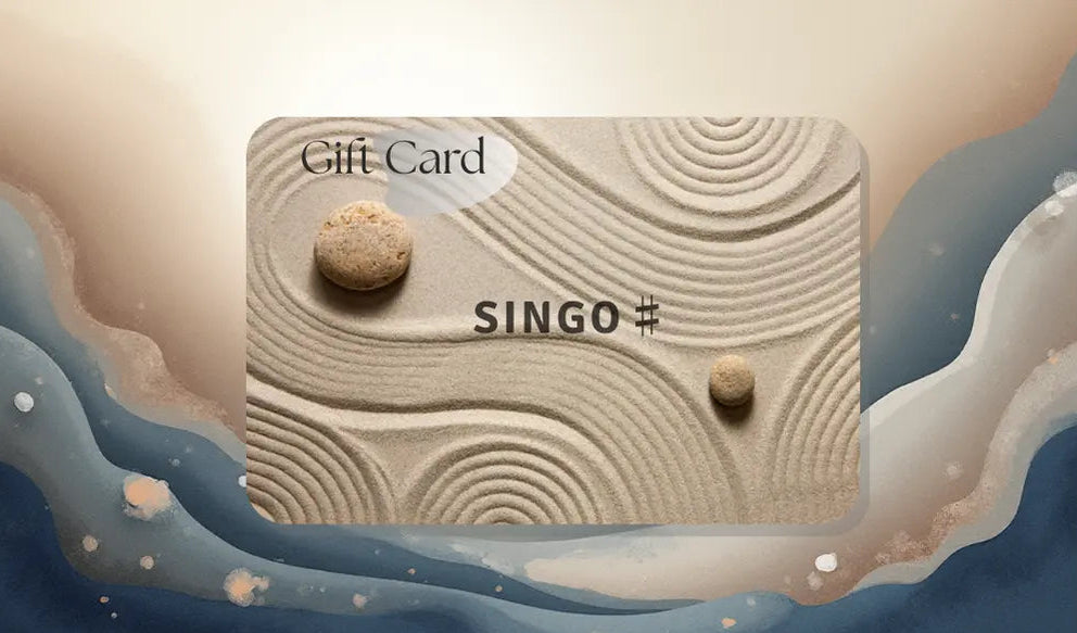 Gift card featuring a sandy texture with circular patterns and smooth stones, showcasing the brand "SINGO" prominently.