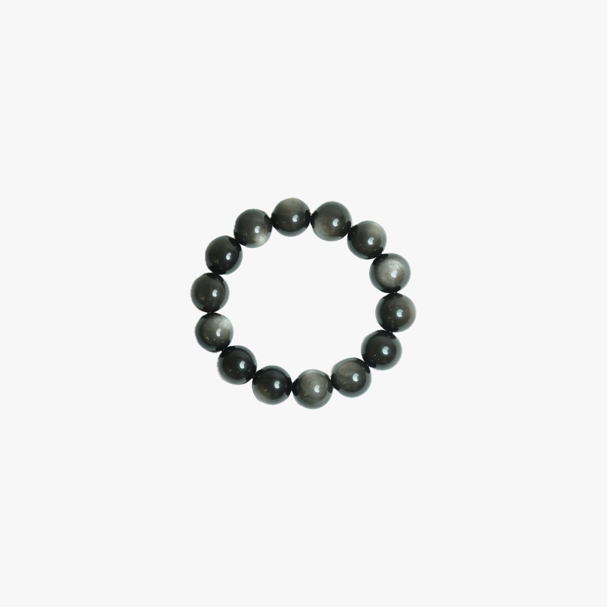 Handcrafted 18mm Silver Sheen Obsidian crystal bracelet with mesmerizing natural chatoyancy, viewed top-down on a clean white background for grounding and reflection at Singoau