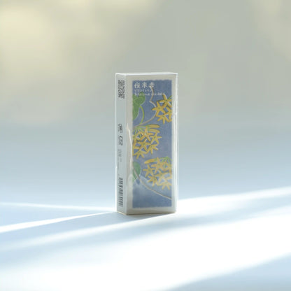Kousaido Ikadenshin Japanese Incense Telosma Cordata on a light surface. The box is mostly white with a blue-green front panel featuring yellow floral artwork and small green text near the top.