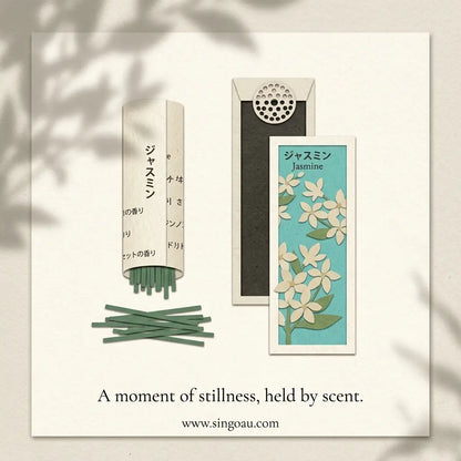 A minimalist kousaido Ikadenshin Japanese Jasmine Incense  illustration showing a scented incense set with a cream-colored paper sleeve, several green incense sticks, a dark rectangular box, and a small card labeled Jasmine with white flowers on a light blue background. The scene is presented on a cream card with soft leaf shadows, and the text reads 'A moment of stillness, held by scent.