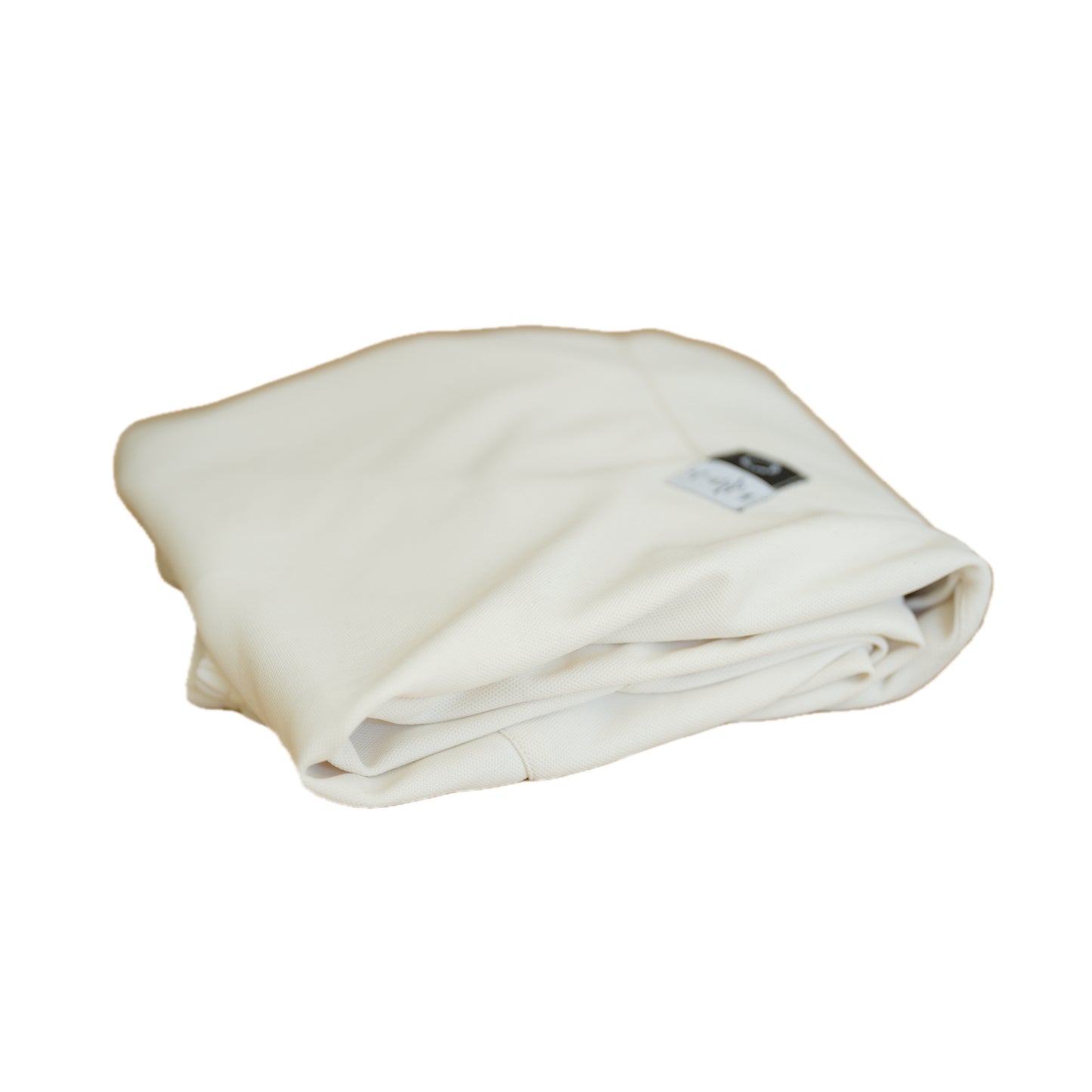 Neatly folded white fabric with a small tag visible, resting on a white background.