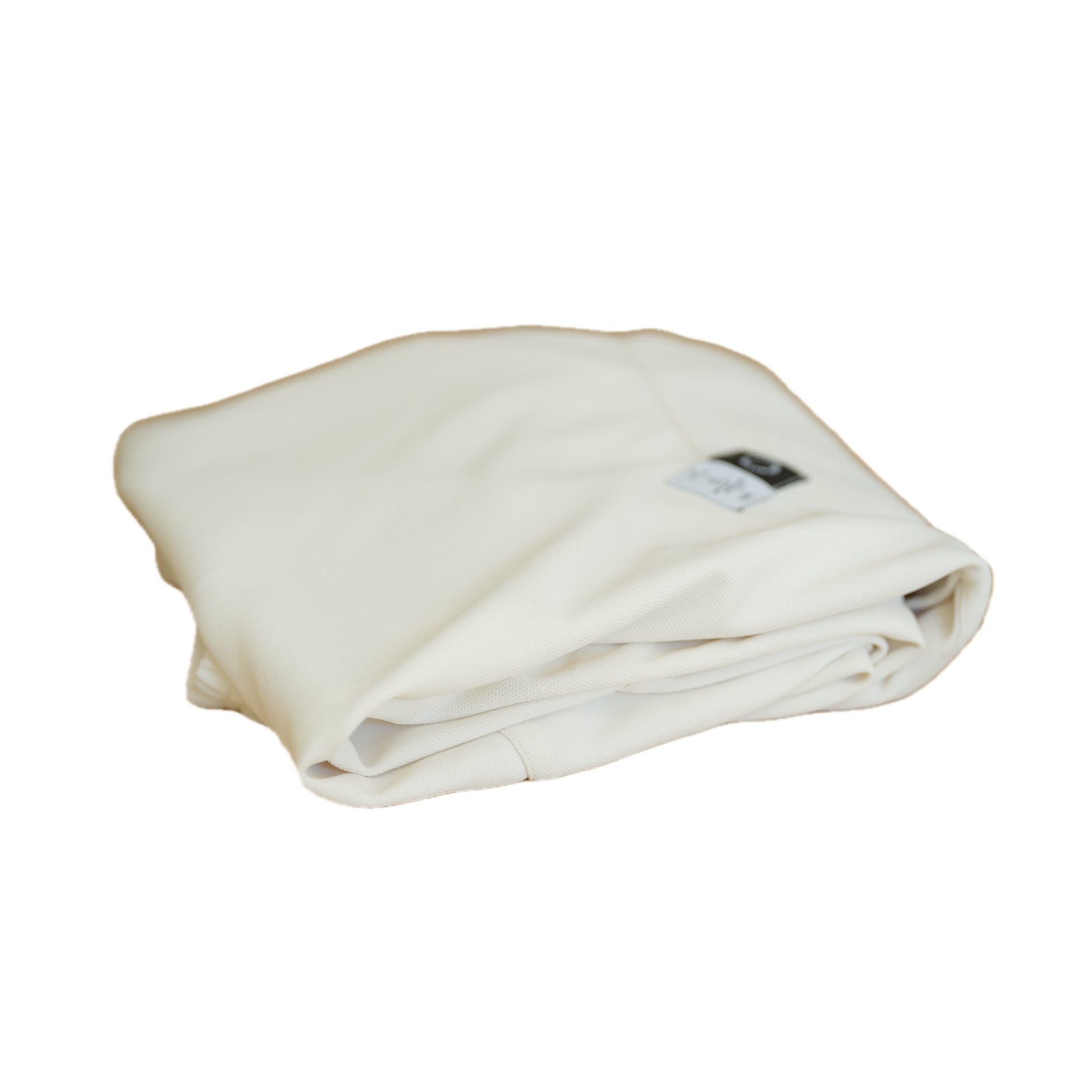 Neatly folded white fabric with a small tag visible, resting on a white background.
