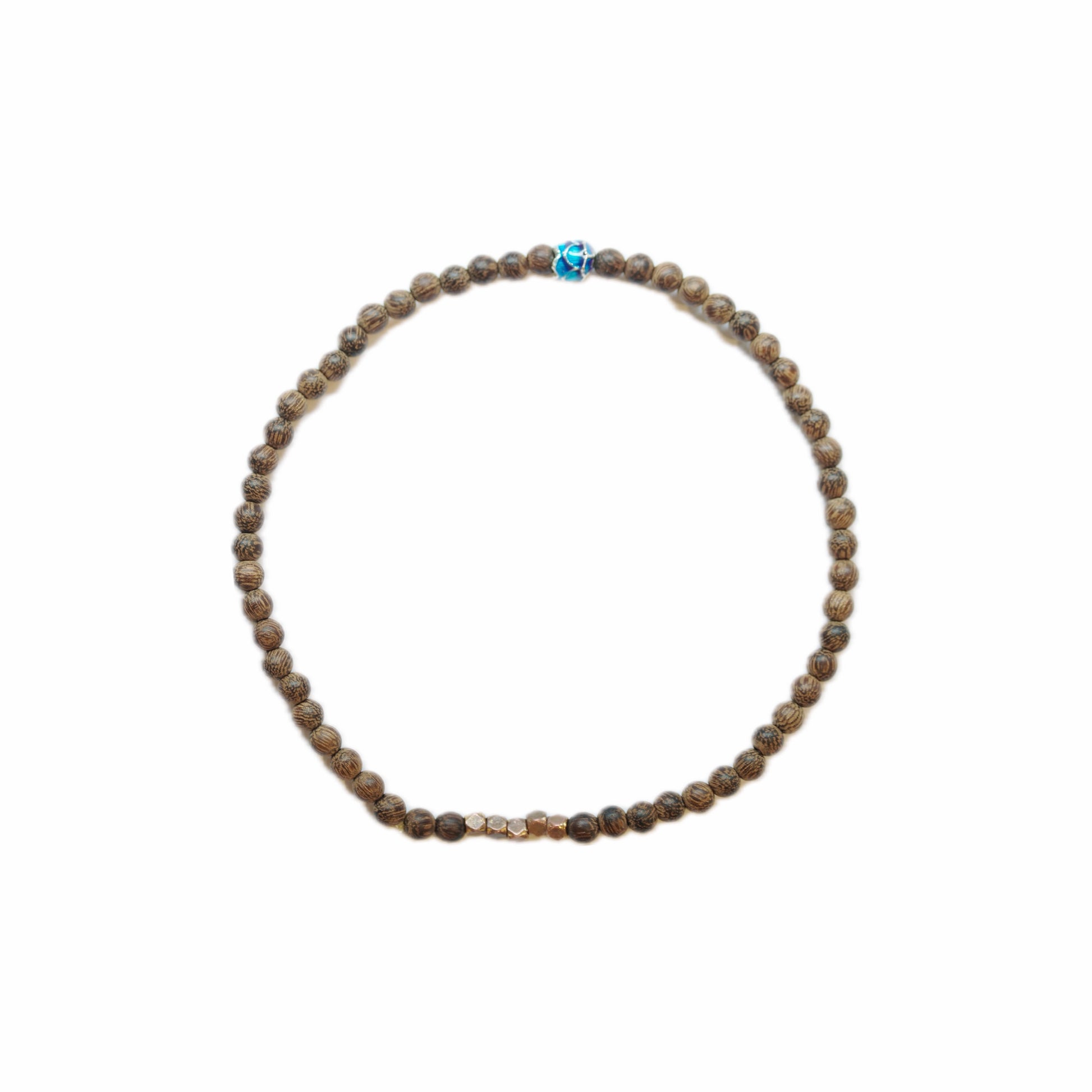 Close-up of a beaded bracelet featuring brown patterned beads, with central gold accent and a vibrant blue decorative bead.