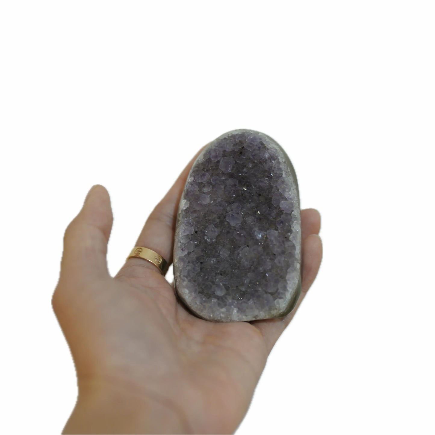 A person's hand holding a large, flat raw amethyst cluster, providing a clear visual representation of its size and deep purple color.