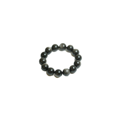 Angled product shot of the substantial 18mm Silver Sheen Obsidian crystal bracelet, highlighting the unique glossy finish and energetic presence of each genuine gemstone bead at Singoau.