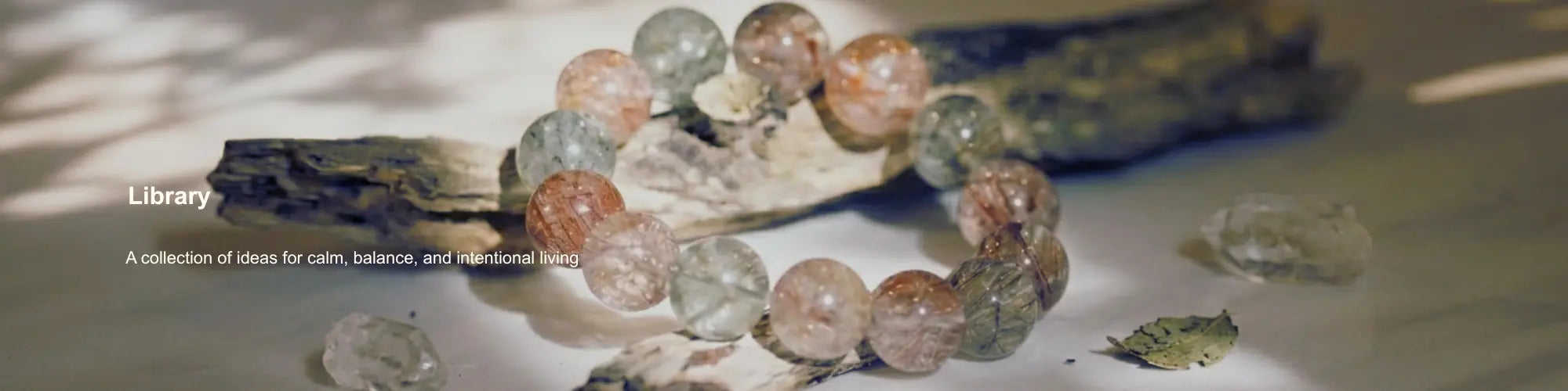 Minimalist crystal bracelet with natural stones on wood, representing calm, balance, and mindful living lifestyle
