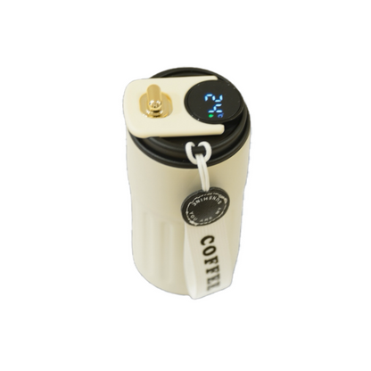 A cream-colored insulated coffee mug with a digital temperature display and a removable strap marked "COFFEE."