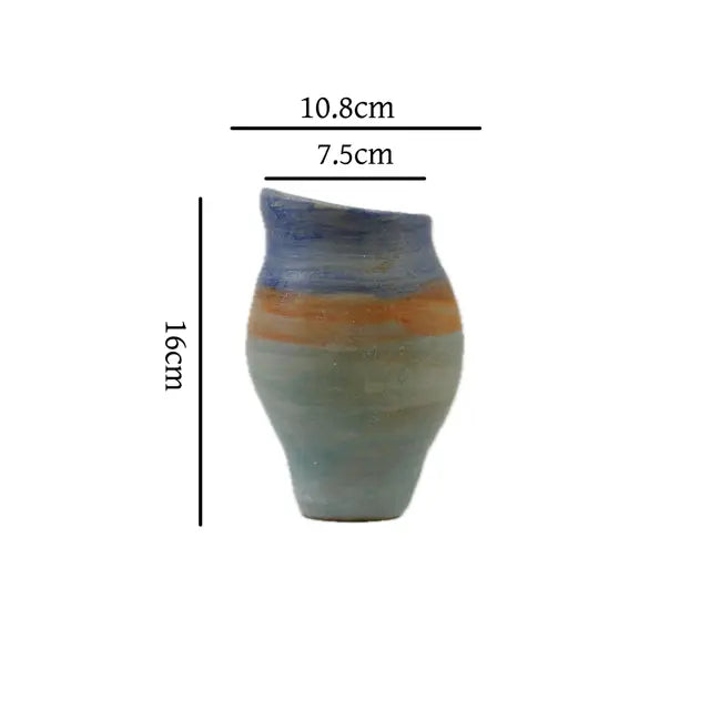 A handcrafted ceramic vase with a blue and orange textured design on a white background, measuring 10.8 cm wide, 7.5 cm deep, and 16 cm tall.