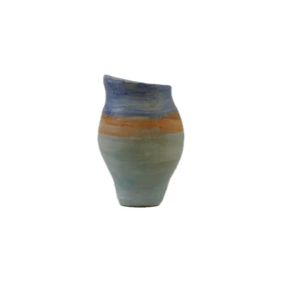 A uniquely shaped ceramic vase with a wavy rim, featuring earthy tones of blue, orange, and beige on a white background.