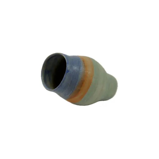 A uniquely shaped ceramic vase in muted green, blue, and orange hues, tilted slightly for a dynamic display on a white background.
