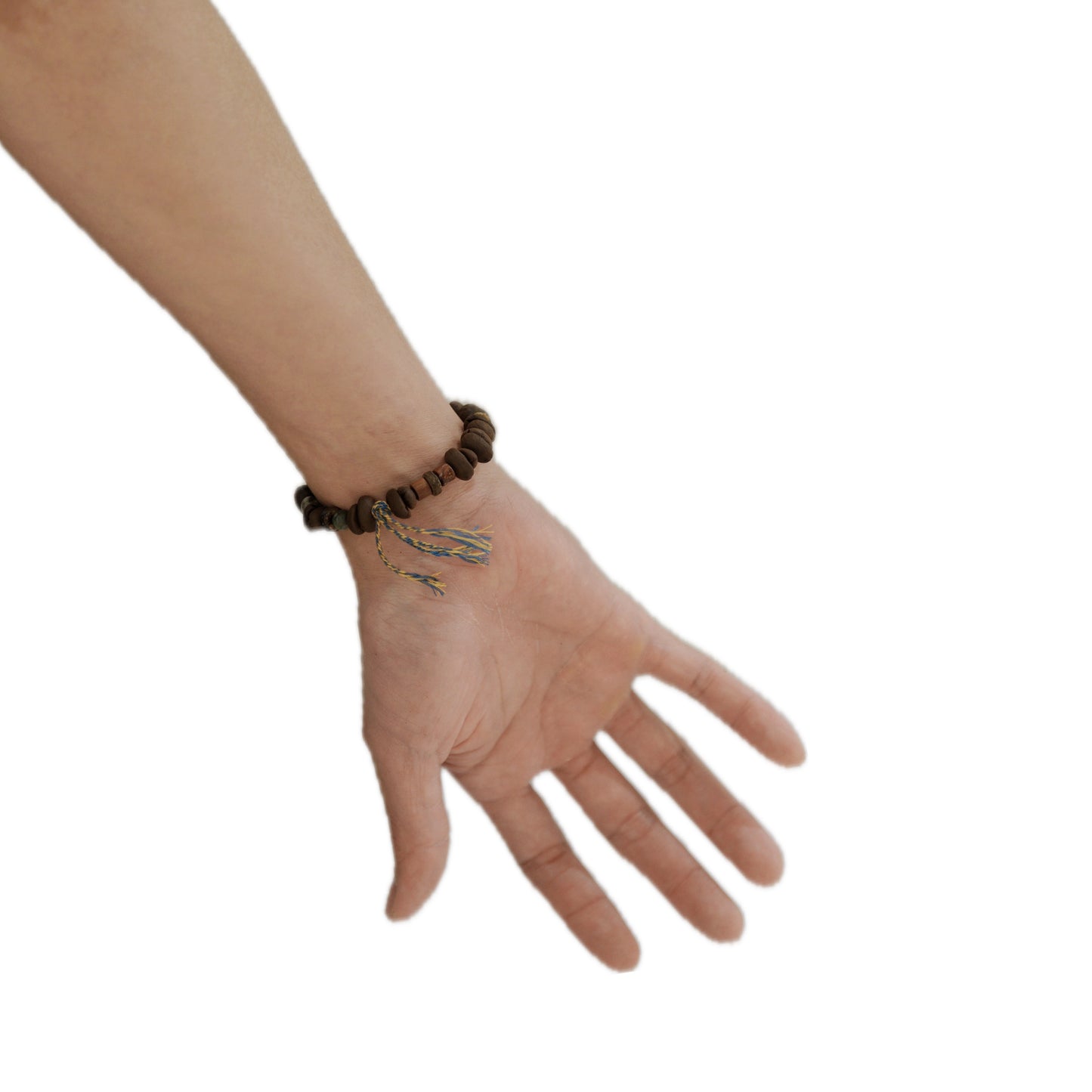 Hand wearing a 'The Intention' bracelet on a white background