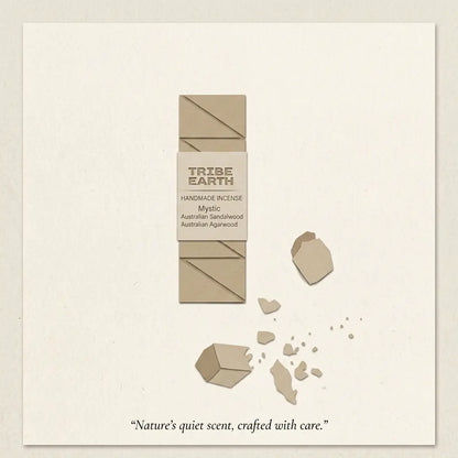 A minimalist product card for Tribe Earth Handmade Incense, featuring a vertical rectangular incense stick in a kraft-paper style with a central label. The card has a textured off-white background, stylized scattered incense pieces, and the scent name 'Mystic' with notes of Australian Sandalwood and Australian Agwood.