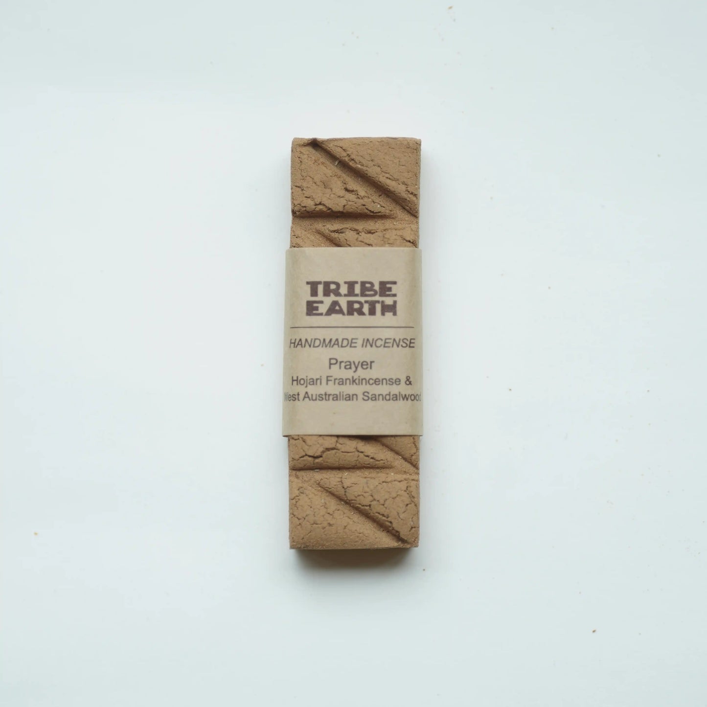 A single rectangular bar of Tribe Earth Handmade Incense wrapped in a kraft paper band, displayed on a clean white background.