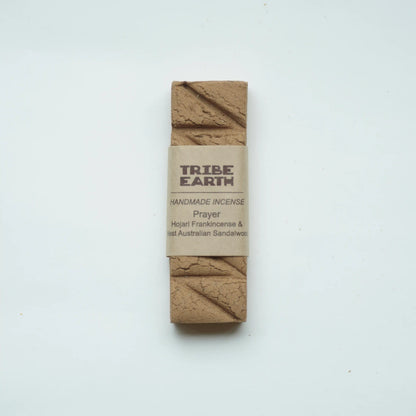 A single rectangular bar of Tribe Earth Handmade Incense wrapped in a kraft paper band, displayed on a clean white background.