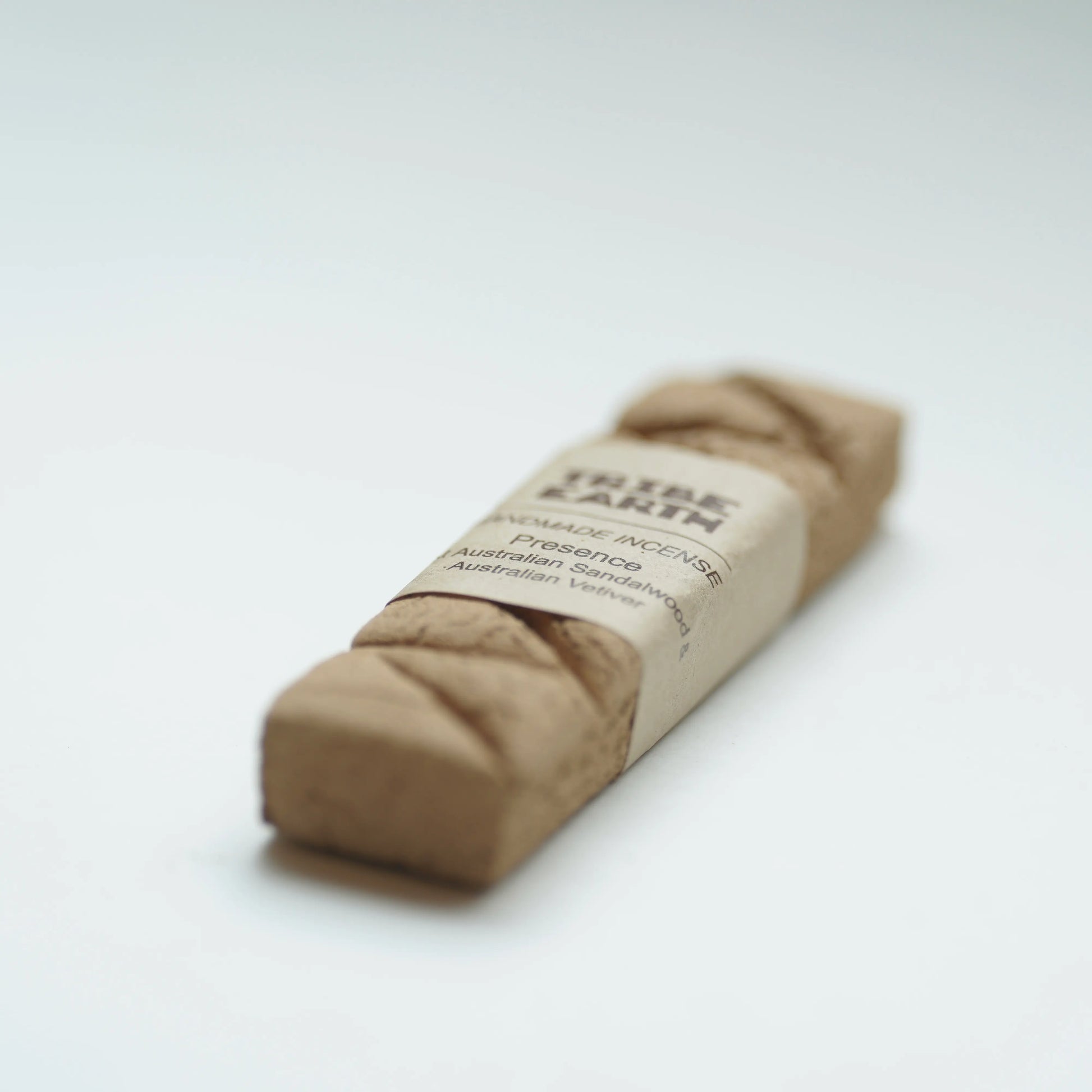 A Tribe earth presence incense on a clean white background.