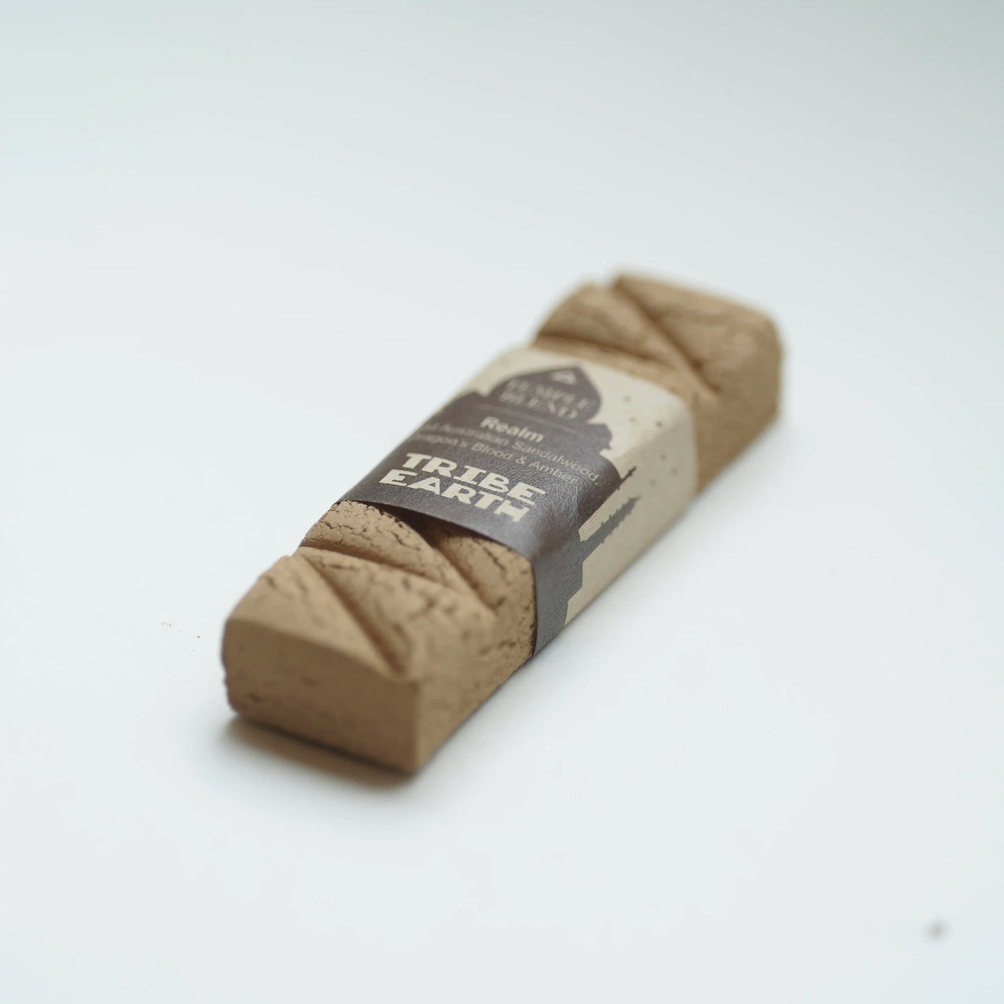 A single Tribe earth realm incense photographed on a clean white background.