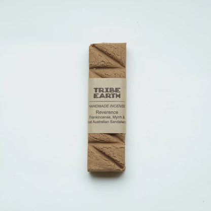 A single rectangular bar of Tribe Earth handmade incense wrapped in a kraft paper label, displayed on a clean white background.