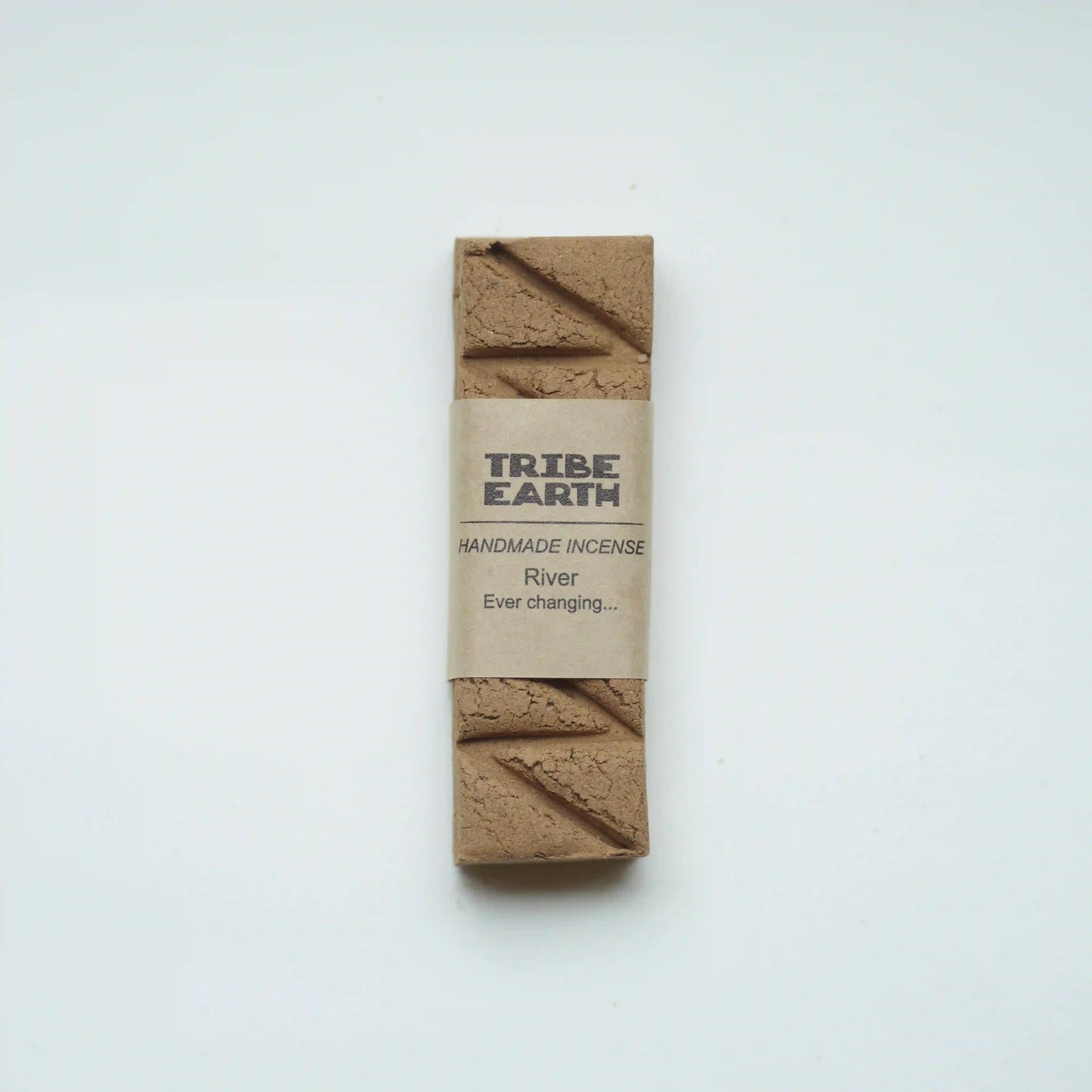 A single bar of Tribe Earth handmade incense labeled 'River Ever changing.