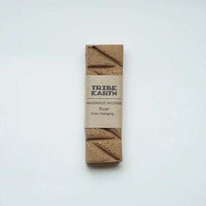 A single bar of Tribe Earth handmade incense labeled 'River Ever changing.