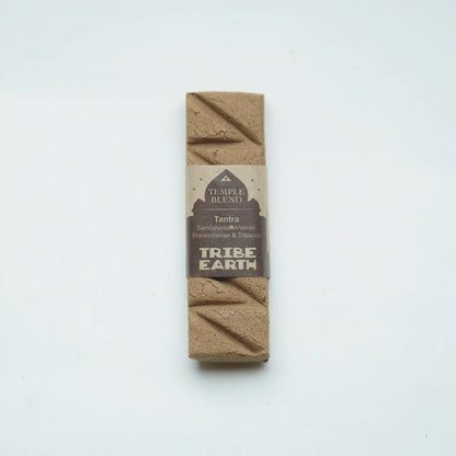 A single rectangular Tribe Earth Temple Blend Tantra coffee bean bar, wrapped in a brown paper label, standing vertically on a plain white background.
