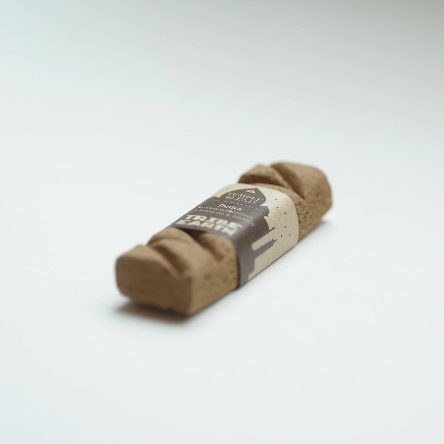 A Tribe earth tantra incense photographed on a clean white background.